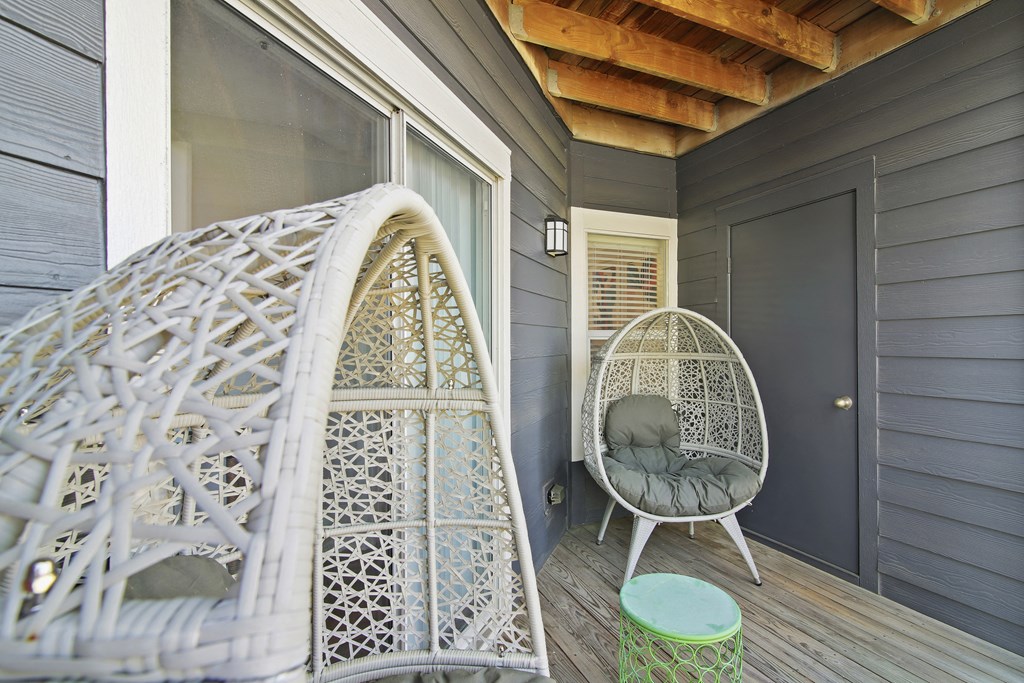 Balcony a porch with a white chair and a hammock at Elme Druid Hills, Atlanta, Georgia